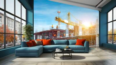 Workers are working on large construction sites and many cranes are working in the construction industry. Wall mural