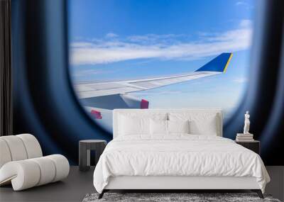 Airplane wing view out of the window the cloudy sky background, Travel and Holiday vacation concept Wall mural