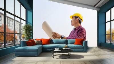 Engineer man holding blueprint checking and planning project at construction site, Man holding blueprint and looking into the sky Wall mural