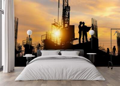 Silhouette of Engineer and worker team on building site, construction site with sunset in evening time Wall mural