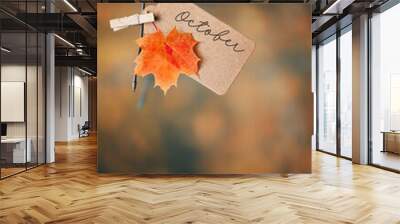 autumn natural background. october time concept. orange maple leaf and paper tag, forest landscape. fall season  Wall mural