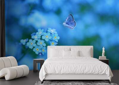 beautiful blue flower and butterfly close up on abstract blurred background. Gentle romantic scene of wild nature. dreamy artistic image. purity of nature, care about ecology of the world concept Wall mural