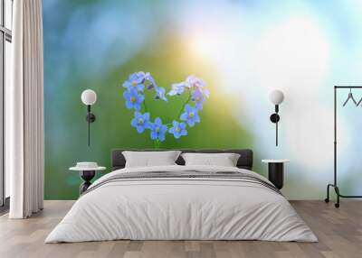 delightful bright scene with flowers forget-me in form of heart. Spring forget-me-not forming blue heart on green nature background. Romantic flower concept, love symbol. copy space Wall mural