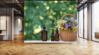 medical amber glass bottles of herbal essential extract or oil and flowers in basket on table, abstract natural green background. eco friendly care organic Cosmetic product. beauty treatment, Spa. Wall mural