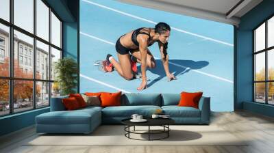 athlete woman in starting position Wall mural