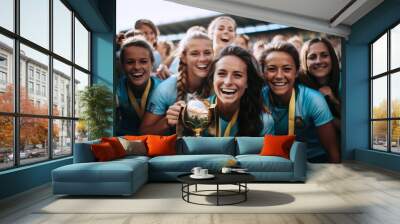 Laughing female athletes with soccer trophy in stadium Wall mural