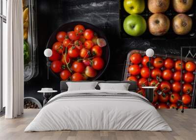 Assorted fresh produce and ingredients on a dark surface Wall mural