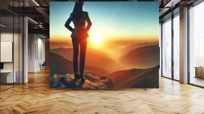 a woman stands on a rock with the sun setting behind her Wall mural