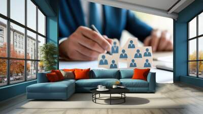 businessman at his desk trying to organise the staff, in a hierarchical way. Wall mural