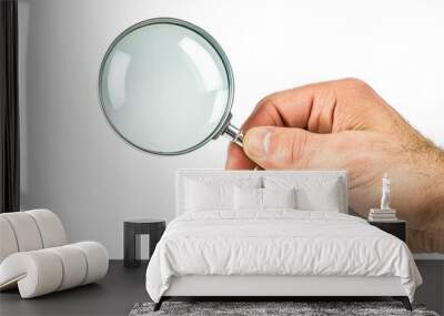 man's hand holding a holding a magnifying glass in silver tone, on white background Wall mural