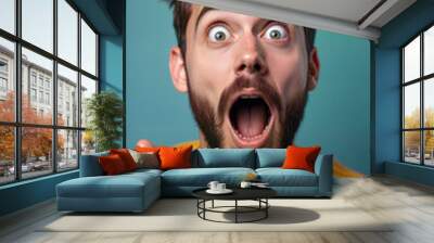 A man with a surprised expression and wide-open mouth points excitedly while wearing a bright yellow shirt. Image is perfect for marketing, social media, and any project that needs a burst of energy Wall mural