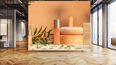 Natural skincare products with fresh citrus and green leaves on a soft orange background Wall mural