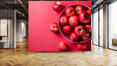 Top view of fresh red apples in a bowl on a red background Wall mural