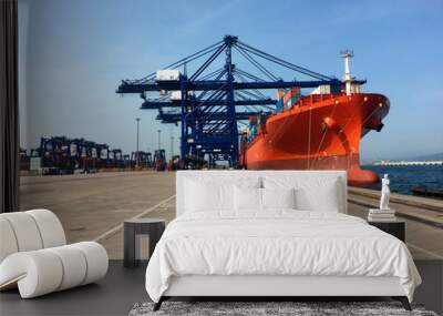 Cranes of dockers loading boat with containers in Algeciras port Wall mural