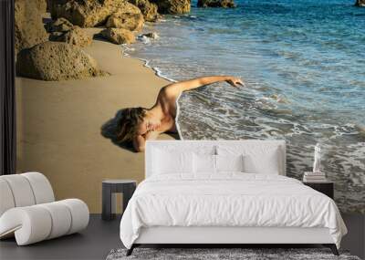 Woman sleeping dressed with the sea shore Wall mural