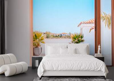 Bright and airy modern indoor space with a stunning view of a sunny outdoor terrace Wall mural