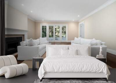 Cozy living room featuring white sofas, two coffee tables, and large windows with natural light, located in a modern home Wall mural