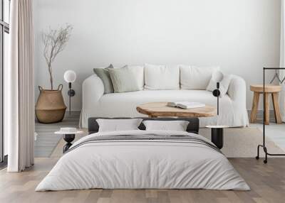 Cozy living room setup with neutral colors, a white sofa, wooden table, and natural decor in a serene space Wall mural