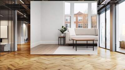 Cozy living room with modern furniture and a large window overlooking a city street in daylight Wall mural