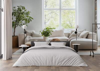 Modern living room with cozy white sectional sofa, lush indoor plants, and a stylish wooden coffee table in bright natural light Wall mural