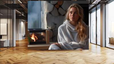 Young woman relaxed in her living room next to the fireplace Wall mural