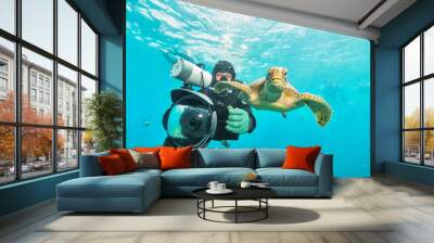 under water photographer diving righ next to turtle Wall mural