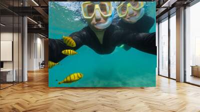 young couple doing snorkeling with stinger suits in the great barrier reef Wall mural