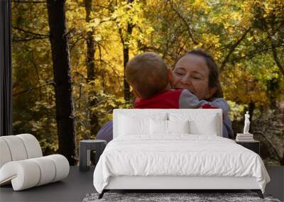 mother hugs her son in a forest Wall mural