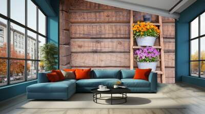 Flowers on ladder shelf lean to wooden wall outside Wall mural