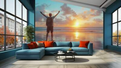 man raising arms up enjoying sunset on the beach looking morning sunrise - Self care, traveling, wellness and healthy life style concept Wall mural