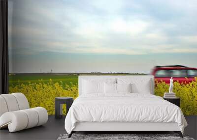 Speeding car and yellow fields Wall mural