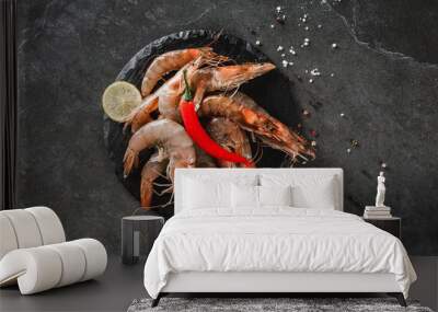 Fresh raw prawns or shrimps with spices on slate stone on dark stone background. Seafood, top view, flat lay, copy space Wall mural