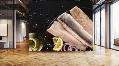 Marinated fillet mackerel or fillet herring fish with spices, greens and slice of bread on plate over dark stone background. Mediterranean food, appetizer, seafood, top view Wall mural