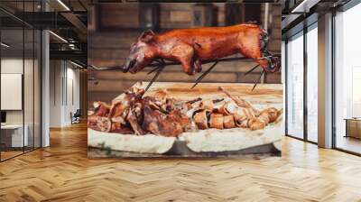 Whole grilled pig with meat steak on cutting board. Hot Meat Wall mural