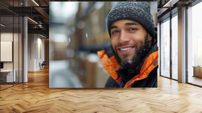 Happy Man Smiling in Winter Outerwear Surrounded by Boxes in a Warehouse Wall mural