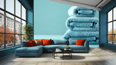 
A stack of spa towels, bath towels stacked on a light blue calm background with space to copy Wall mural