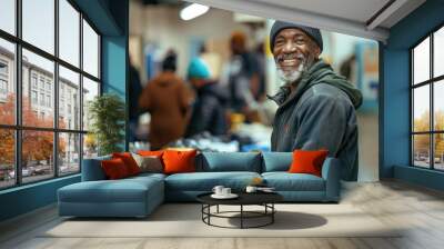 Joyful middle-aged black homeless person enjoys a meal at a social center. Wall mural