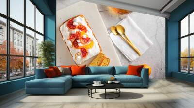 orange sponge cake garnished with fresh bloody oranges and cream and glass teapot on marble surface. Copy space Wall mural