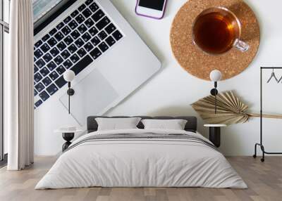 workspace with laptop white and gray notepad and palm leaf and phone. two notepads lie on a plain background with a pen. business concept for meeting in boho style. space for writing in the style  Wall mural