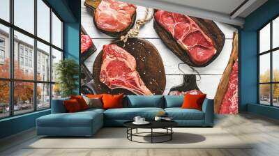 Set of various raw meat steaks. Fresh meat of beef, pork, veal, chicken, steak t-bone, rib eye, tomahawk, ribs, tenderloin on cutting board over white background. Meat food, butcher shop, top view Wall mural