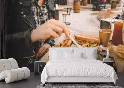 A woman's hand takes the ready-to-eat shrimp. Sea food in paper boxes on the table. Street food Wall mural