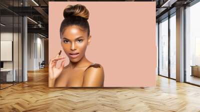 Beautiful portrait black young woman African American with perfect skin and a gentle makeup in pink shades. face and body peeling. beauty. Close-up. coffee scrub on the shoulder. Isolated. - Image  Wall mural