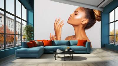 Beauty. Beauty Portrait of a black woman in profile touching fairy hands. makeup. perfect skin. beauty. Close-up.  Isolated  Wall mural