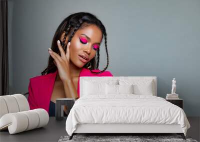 Fashion Portrait Black Woman in Pink stylish jacket. Pink Makeup curly hair and braids. luxury Fashion model African American posing in studio against a pink wall. Beautiful black woman   Wall mural