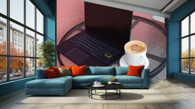 Laptop with a cup of coffee on the terrace Wall mural