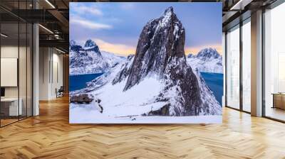 Segla mountain peak seen from Hesten trail near Fjordgard on Senja island, Norway in winter. Scenic winter landscape with snowy mountains range and cold fjord water at sunset Wall mural