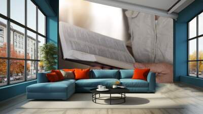 Midsection of a woman reading a bible Wall mural