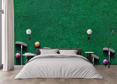 multiple mini golf clubs and balls on putting green background with copy space Wall mural