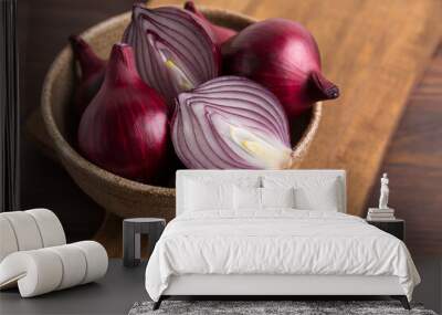 Organic red onions on a wooden background, fresh raw vegetables. Wall mural