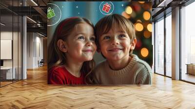 Photo portrait of two children dreaming about gifts, festive Christmas background with blurred garland lights Wall mural